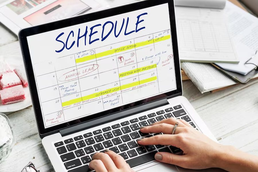 A laptop open to a calendar of scheduled appointments