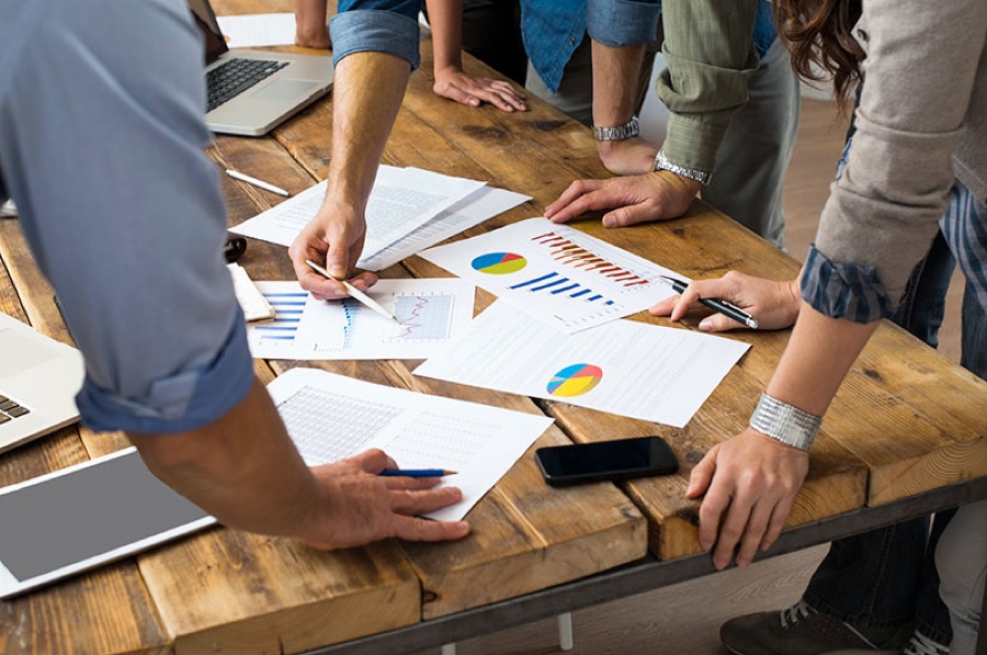 A team reviewing reports and charts at a desk
